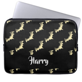 Guld fladdermöss på svart laptop fodral
