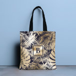 Guld flotta i den tropiska Blommigten Tygkasse<br><div class="desc">Den här moderna chicen har ett monogram på grund av ett tropiskt blommönster i guld och marinblått. #blommigt #tropical #navy #navyblue #guld #golden #botanical #foliage #personlig #monogram #monogrammed #initial #elegant #chic #snyggt #modern #feminin #tote #påsar #totebag #accesar #office #work #school #giftsforher #personalizedgifts #personalizedgifts</div>