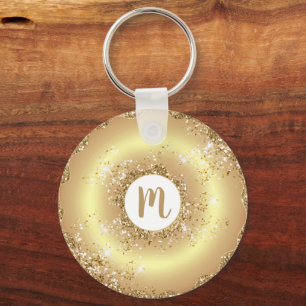 Guld glitter-munnötsmonogramskript med gigantisk l nyckelring