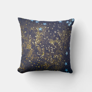 Guld glitter och glittrande blå stjärnor på svart kudde