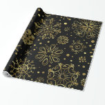 Guld jul Snöflingor på Black Presentpapper<br><div class="desc">Elegant guld toner christmas abstrakt snöflingor över bakgrunden som du kan ändra på webbplatsen. Guld snöflingor kom med öppen bakgrund.</div>