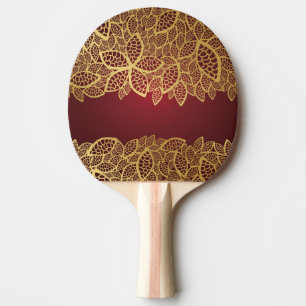 Guld- lövsnöre på röd bakgrund pingisracket