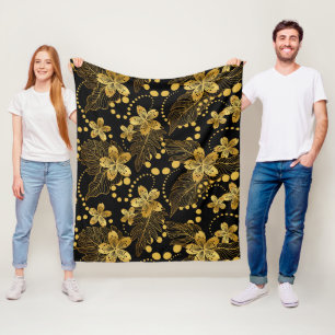 Guld på svarta tropiska blommor och löv fleecefilt