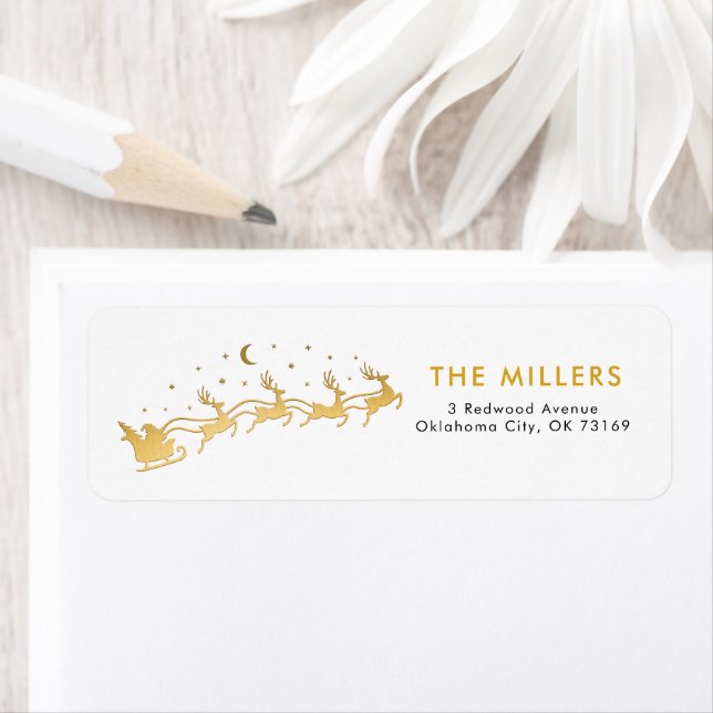 Guld Santa flyger i ett sleigh med renar Returadress Etikett (Insitu)