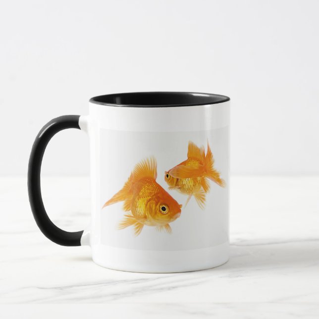 Guldfisk som två korsar varje annan mugg (Vänster)