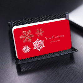 guldvit snöflingor mot rött visitkort