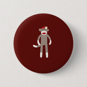 Gullig flickasock monkey på rött knapp