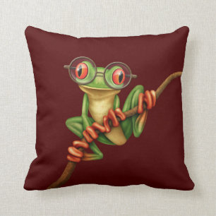 Gullig grön trädgroda med ögaexponeringsglas p kudde