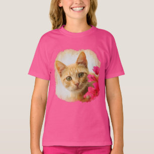 Gullig ljust rödbrun kattkattunge som håller t-shirt