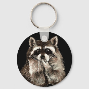 Gullig Raccoon som blåser konst för kysshumordju Nyckelring