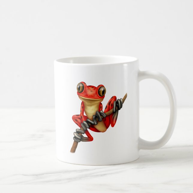 Gullig röd trädgroda på en gren kaffemugg (Höger)