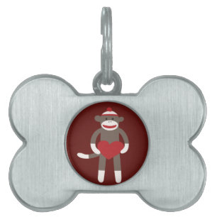 Gullig sock monkey med hattinnehavhjärta namnbricka husdjur