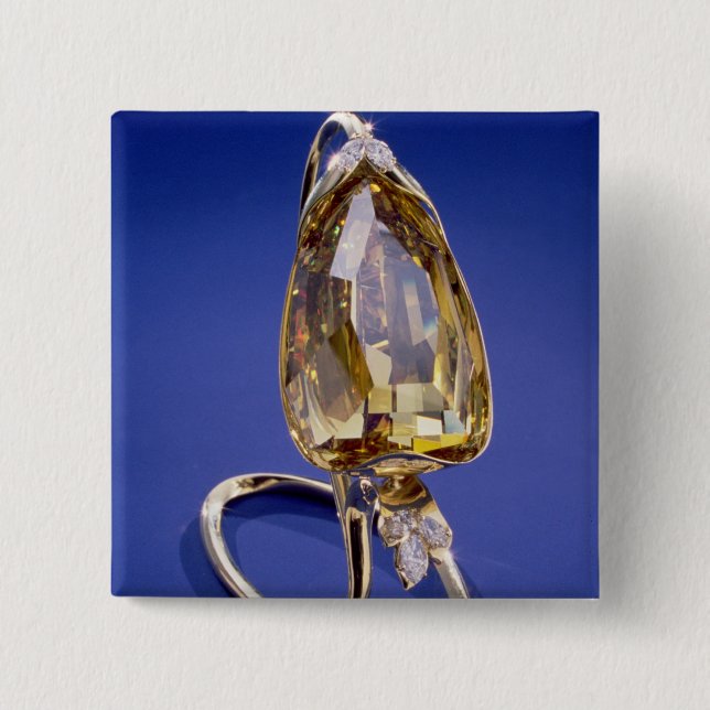 Gulna "den enastående" diamanten i en guld- knapp (Framsida)