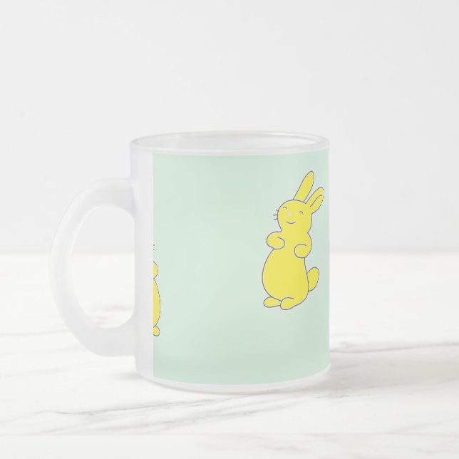 Gult lycklig bunnier på teal frostad glasmugg (Vänster)