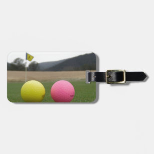 gult och rosa golf bollar, bagagebricka