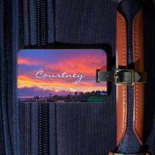 Gult rosa blue clouds sunset kustfotot namn bagagebricka
