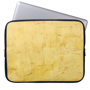 gultens abstrakt texturerat plåster på väggen laptop fodral