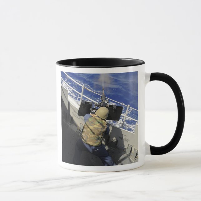 Gunners Mate som avfyrar ett 50 kaliber maskin-vap Mugg (Höger)