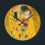 Gustav Klimt the Kiss Rund Klocka<br><div class="desc">Sluss med Gustav Klimts oljemålning med guld löv Kiss (1908). En man och kvinna,  som bär briljant gyllene färg,  tar gärna till sig och kysser i ett fält av blommor. En underbar gåva till fläkt av Art nouveau och österrikisk konst.</div>