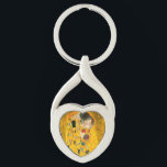 Gustav Klimt the Kiss Twisted Heart Silverfärgad Nyckelring<br><div class="desc">Nyckelkedja med Gustav Klimts oljemålning med guld löv Kiss (1908). En man och kvinna,  som bär briljant gyllene färg,  tar gärna till sig och kysser i ett fält av blommor. En underbar gåva till fläkt av Art nouveau och österrikisk konst.</div>