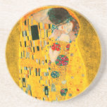 Gustav Klimt the Kiss Underlägg<br><div class="desc">Sandstone Underlägg med Gustav Klimts oljemålning med guld löv Kiss (1908). En man och kvinna,  som bär briljant gyllene färg,  tar gärna till sig och kysser i ett fält av blommor. En underbar gåva till fläkt av Art nouveau och österrikisk konst.</div>