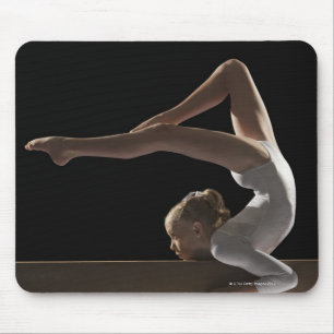 Gymnast på balansbom musmatta