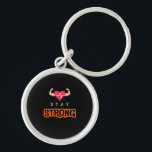 Håll dig stark rund silverfärgad nyckelring<br><div class="desc">Bär motståndskraft med varje bära. Konstruktionen "Håll dig stark" är en påminnelse om att styrkan kommer inifrån,  oavsett utmaningar.</div>