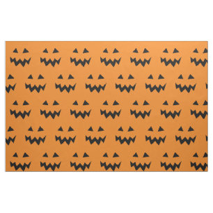Halloween tyg med det sned pumpaansiktemönster