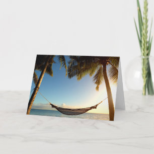 Hängmatta mellan palmträd på tropisk strand kort