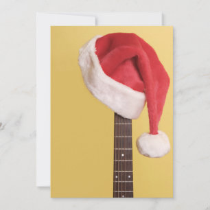 Hängningar för en Santa hatt på en akustisk gitarr Julkort