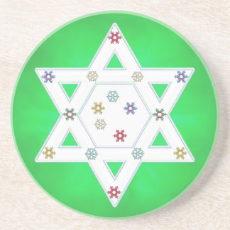 Hanukkah-stjärna och snöflingor på grönt underlägg sandsten