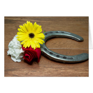 Hästskon på trä med tre blommor ur trippeln hälsningskort