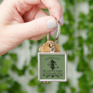 Herbalisk grönt trollar naturmedicin fyrkantig silverfärgad nyckelring