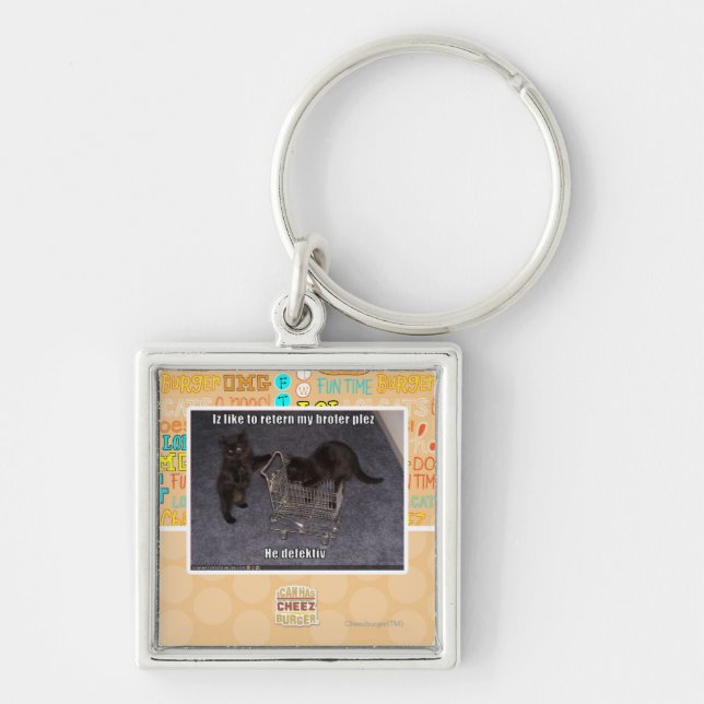 Honom defectiv fyrkantig silverfärgad nyckelring (Framsidan)