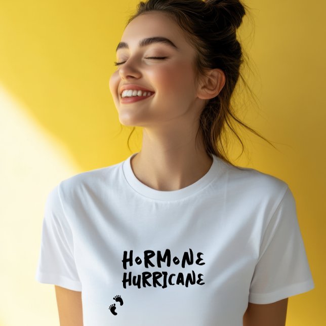 Humorous pregnancy baby fingerprint black t shirt (Accompanying this striking visual is the lighthearted and amusing phrase "Hormone Hurricane,")