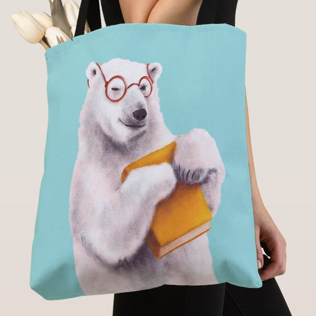 Isbjörn Bokälskare Nörd Tygkasse (close up of a blue tote bag with polar bear book lover with eyeglasses and yellow book)