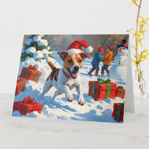 Jack Russell som springer i snö med julhatt Kort