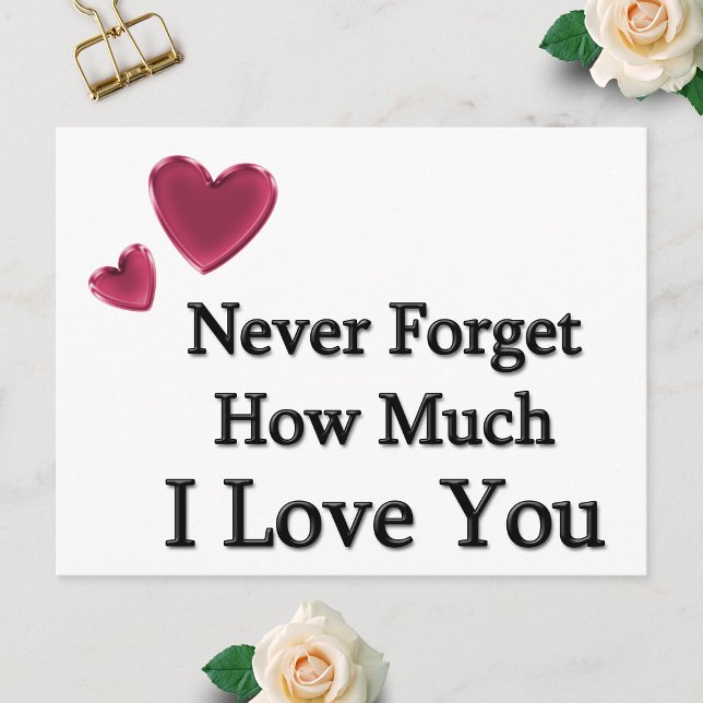 Jag älskar dig vykort (Postcard showing Never Forget How Much I Love You with two hearts, laid flat on a white surface.)