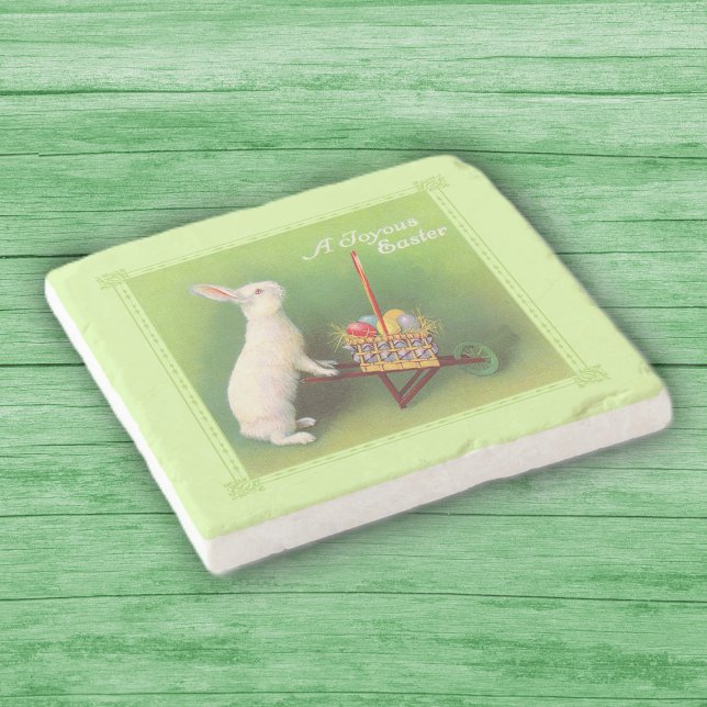Joyous Påsk White Rabbit Basket Eggs Wheelbarrow Stenunderlägg (White rabbit pushing wheelbarrow full of colored Easter eggs on green stone drink coaster.)