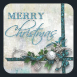 Jude Teal och Silver Joy till världen Fyrkantigt Klistermärke<br><div class="desc">Riktigt lagrad design i djup teal och silver med satingband, pärlor, en silver-filigree-stjärna, diamant nyckel, silver ornament och holly. Texten präglas av en liten aning glitter. Bakgrunden är texturerad och nedtryckt med dubbla högdagrar. Anm.: Skuldade, graverade, präglade och dimensionella effekter, skiktade, åldras eller eroderade utseenden, struktur och skuggor som uppnås...</div>