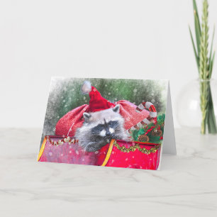 Jul Raccoon lounging in Santa's Sleigh Helgkort