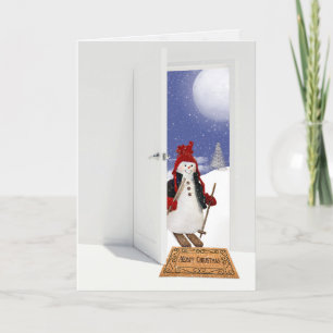 Jul snögubbe på skidor i närheten helgkort