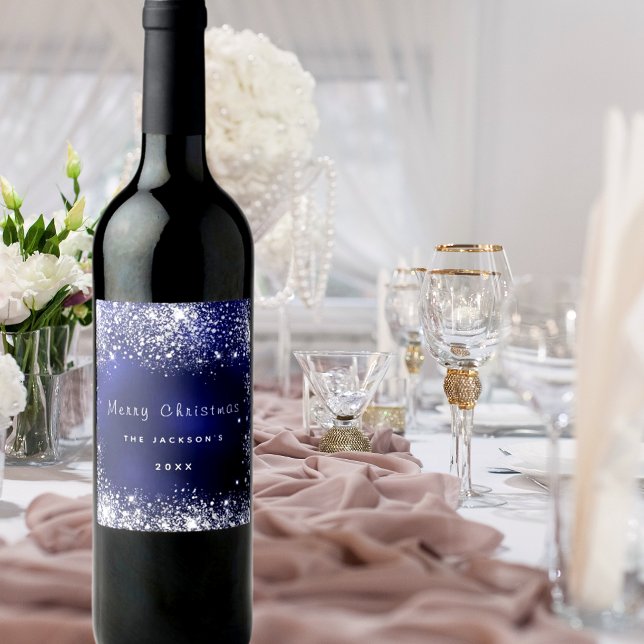 Julblåvitt damm från glitter silver vinflaska etikett (Skapare uppladdad)