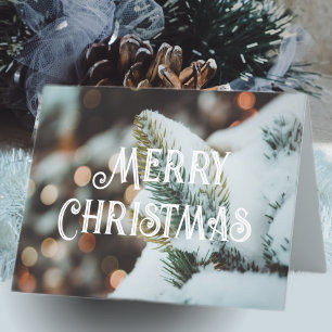 Julgrisen gren och ljus under vintern helgkort