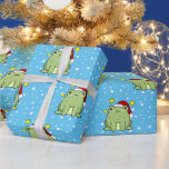 Julgrodd Presentpapper<br><div class="desc">Julgrodan i lycklig grönt,  i gryningen,  med en röd och vit julhatt på blå bakgrund med mycket vitt snöflingor.</div>