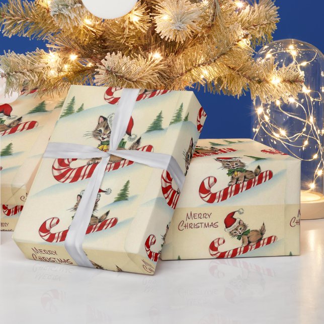 Julig kattunge ridande på en sockerrörspinne presentpapper (Helgdagar)