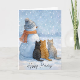 Julkatten sitter med en snöman i ett fält kort
