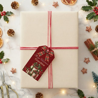 Julklappspåse med röd burgunderrutig slinga och eg presentetikett