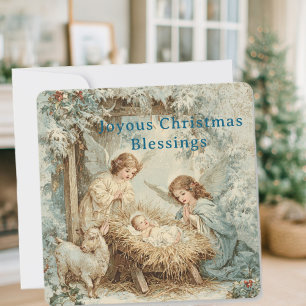 Julkort med baby Jesus i en krubba och änglar