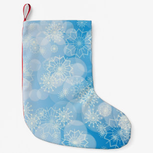 Julsnöflingor på en blå bakgrund liten julstrumpa